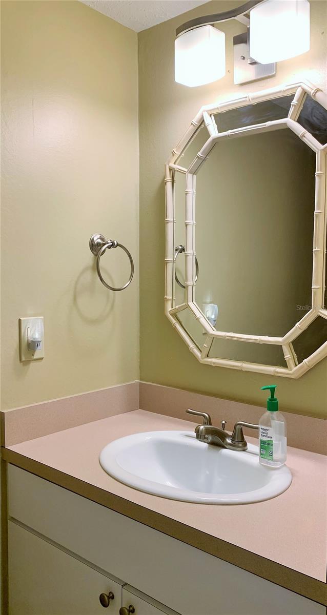 bathroom with vanity and a textured ceiling