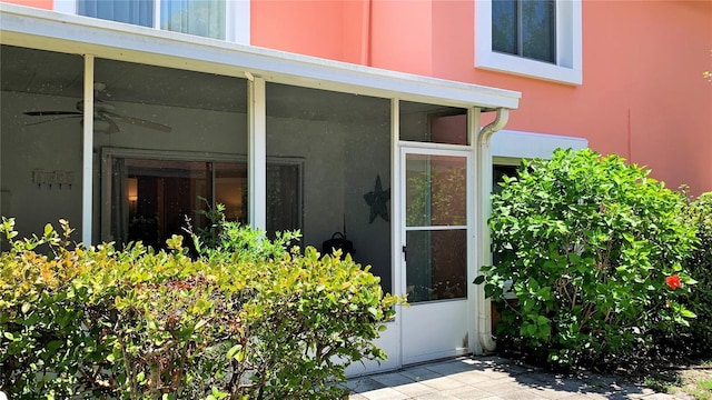 entrance to property with ceiling fan