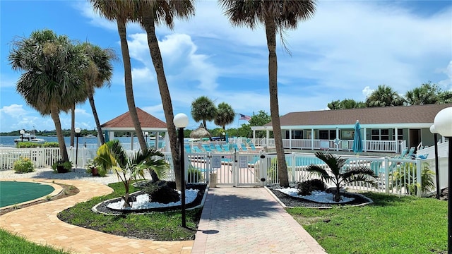 view of pool with a water view, a gazebo, and a yard