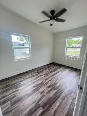 spare room with a healthy amount of sunlight, wood-type flooring, and ceiling fan