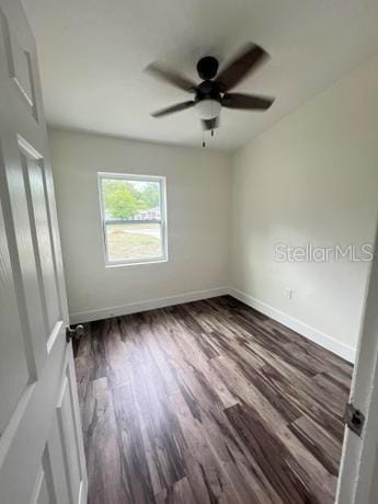 spare room with hardwood / wood-style floors and ceiling fan