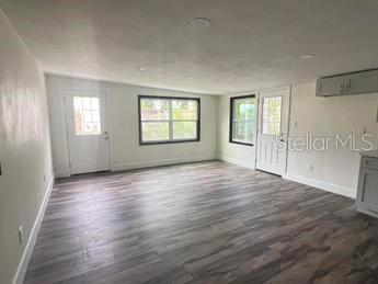 empty room with dark wood-type flooring