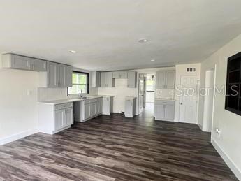 kitchen with gray cabinets and dark hardwood / wood-style flooring