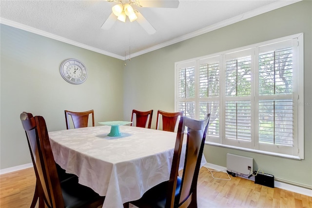 dining area with crown molding, light hardwood / wood-style floors, and ceiling fan