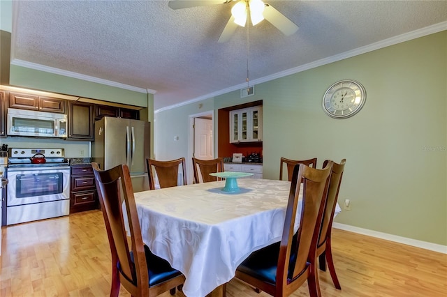 dining space with ornamental molding, ceiling fan, a textured ceiling, and light hardwood / wood-style floors