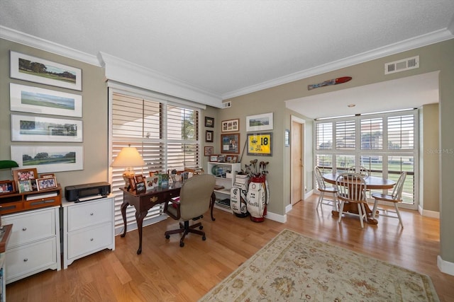 office with plenty of natural light, visible vents, and crown molding