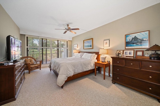 bedroom featuring a ceiling fan and light colored carpet