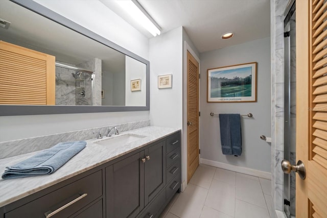 full bath featuring a stall shower, vanity, a closet, and tile patterned floors