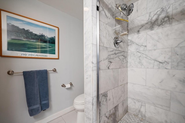 bathroom with toilet, baseboards, a tile shower, and tile patterned floors