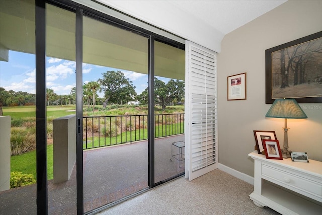 doorway to outside with carpet floors and baseboards