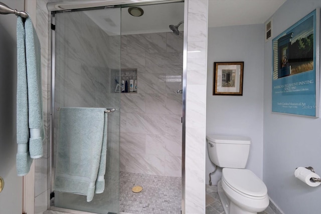 full bath with toilet, a stall shower, and visible vents