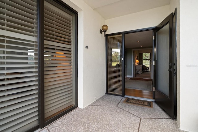 property entrance with stucco siding