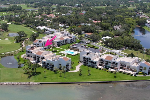 drone / aerial view featuring golf course view and a water view