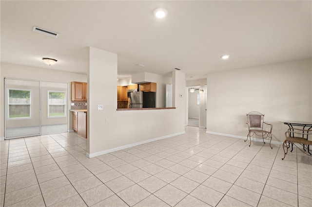 unfurnished living room featuring light tile patterned floors