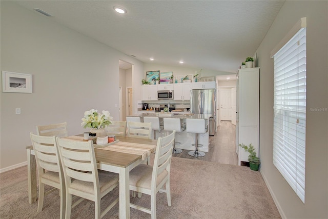 dining area featuring baseboards, vaulted ceiling, a textured ceiling, and recessed lighting