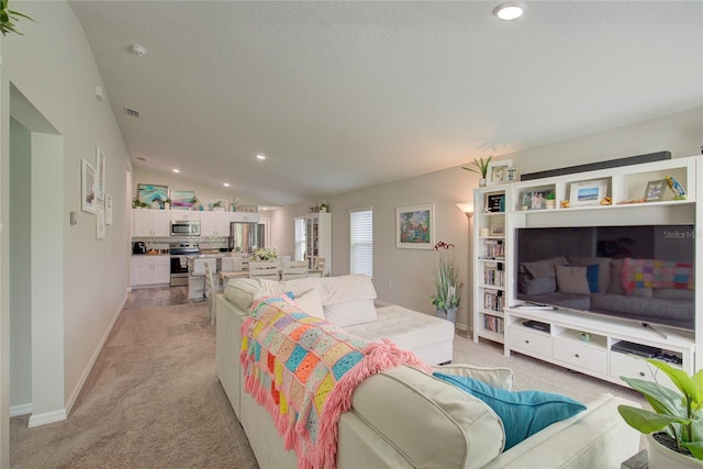 living room with lofted ceiling, recessed lighting, baseboards, and light colored carpet