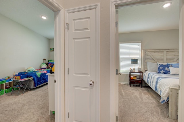 bedroom with recessed lighting, light colored carpet, and baseboards