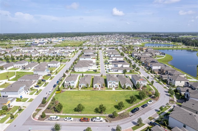 drone / aerial view featuring a water view and a residential view