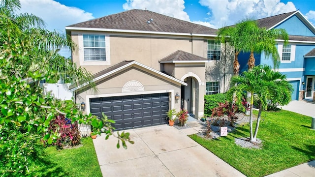 view of front of property featuring a garage and a front lawn