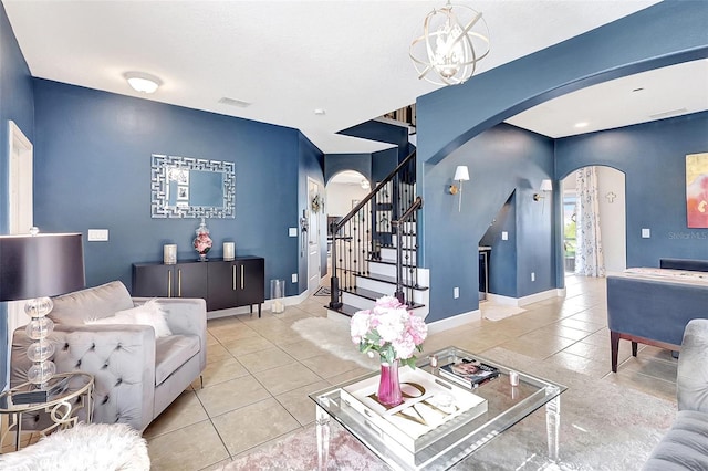 living room featuring a notable chandelier and light tile patterned floors