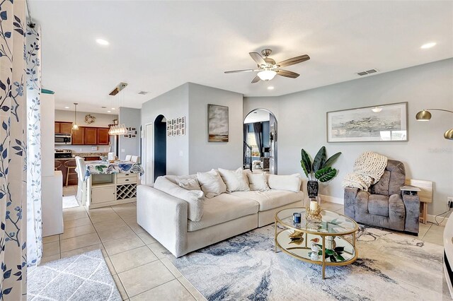 living room with ceiling fan and light tile patterned floors