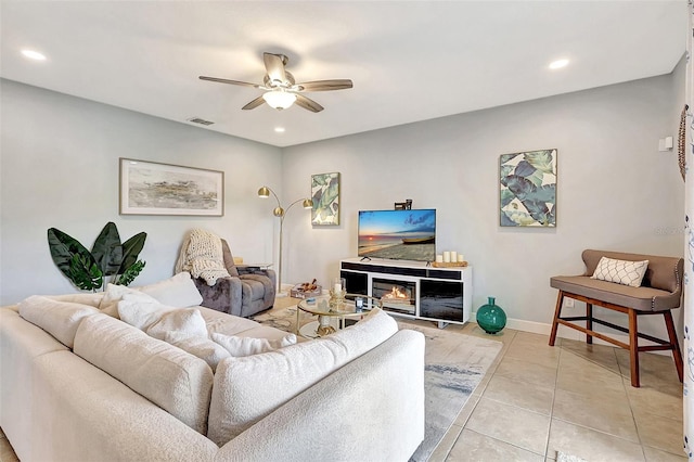 living room with light tile patterned floors and ceiling fan