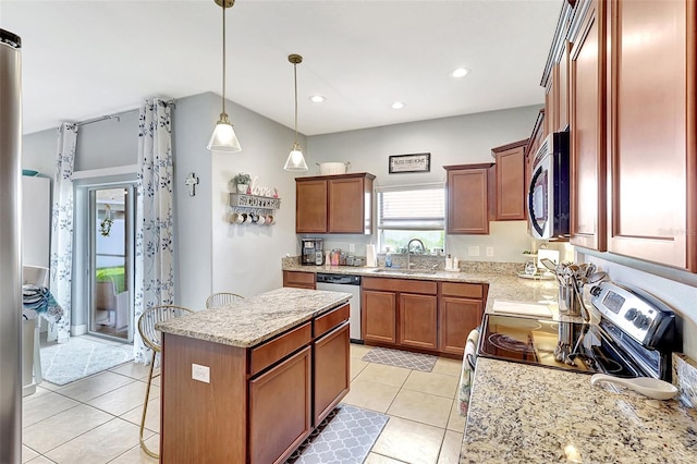 kitchen with pendant lighting, sink, a kitchen island, appliances with stainless steel finishes, and light tile patterned floors