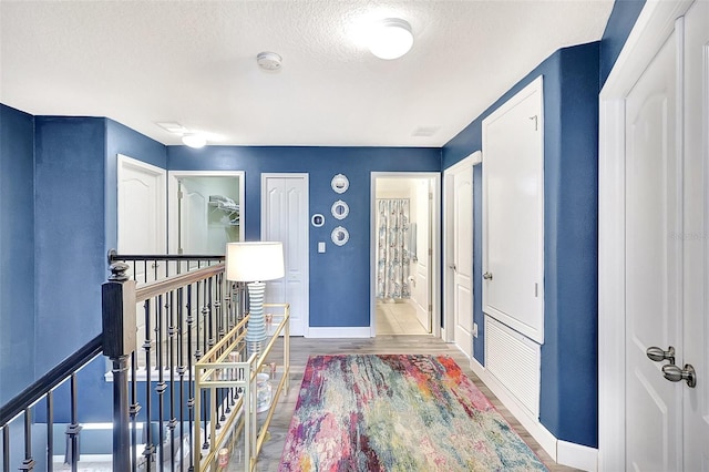 entrance foyer with hardwood / wood-style flooring and a textured ceiling