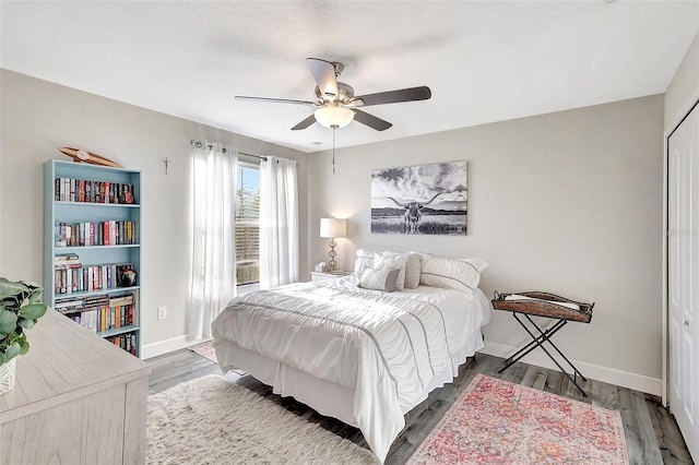 bedroom featuring ceiling fan, hardwood / wood-style floors, and a closet