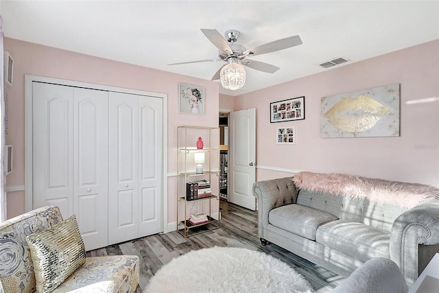 living room with hardwood / wood-style floors and ceiling fan