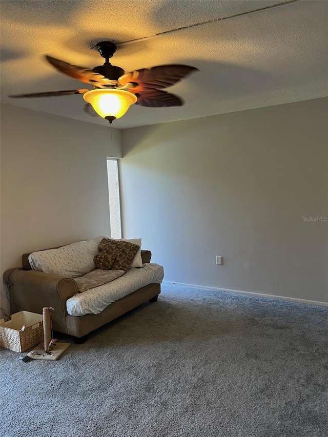 living room with a textured ceiling, carpet, and ceiling fan