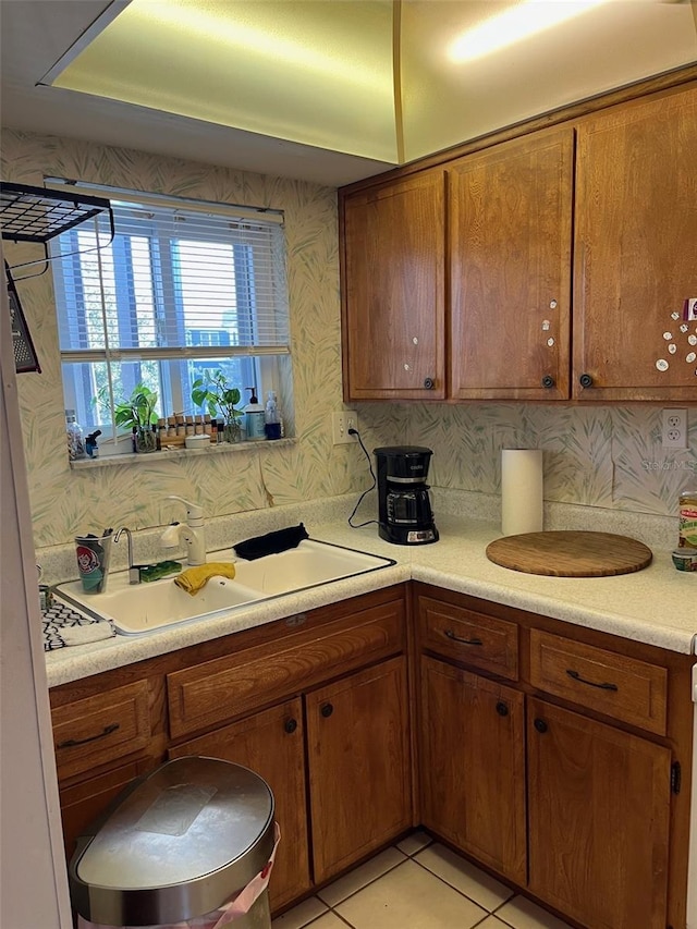 kitchen featuring light tile patterned flooring, backsplash, and sink