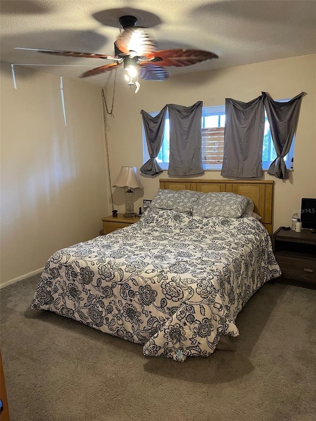 carpeted bedroom featuring a textured ceiling and ceiling fan