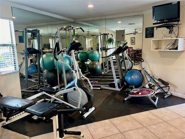 exercise room with ceiling fan, tile patterned flooring, and ornamental molding