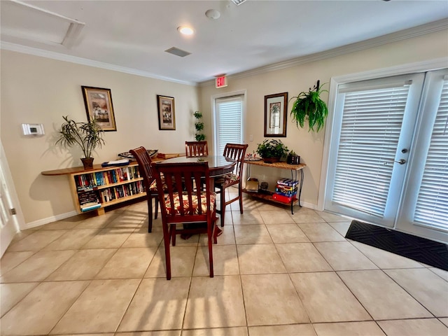 dining space featuring light tile patterned floors and crown molding