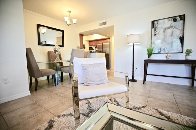 sitting room featuring ornamental molding, light tile patterned floors, and an inviting chandelier