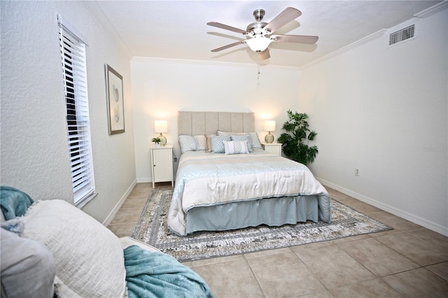 tiled bedroom with ceiling fan and crown molding