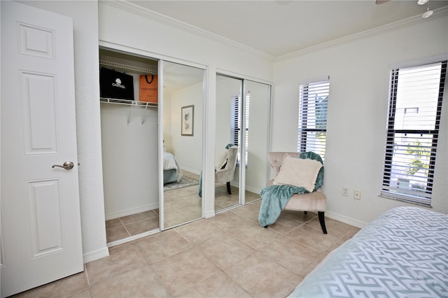 tiled bedroom with two closets and crown molding