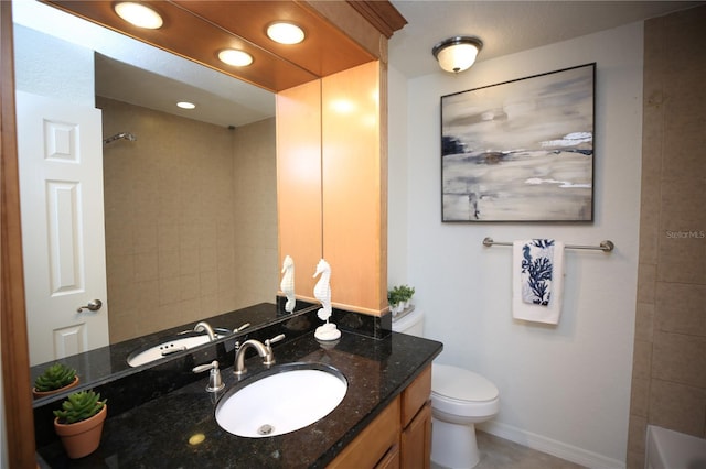 bathroom featuring vanity, toilet, and a bathing tub