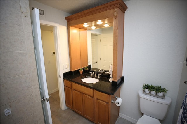 bathroom with tile patterned floors, vanity, and toilet