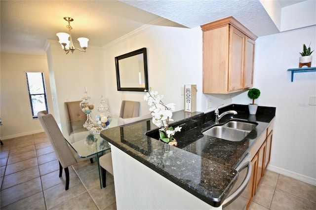 kitchen featuring an inviting chandelier, sink, dark stone countertops, ornamental molding, and light tile patterned floors