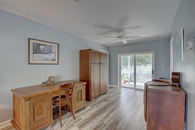 office space with ceiling fan and light hardwood / wood-style flooring