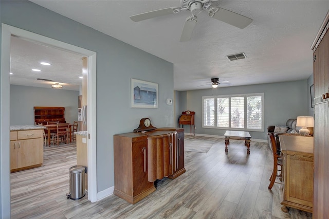 interior space featuring a textured ceiling and light wood-type flooring