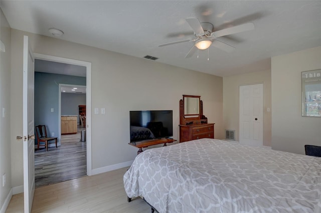 bedroom with light wood-type flooring and ceiling fan