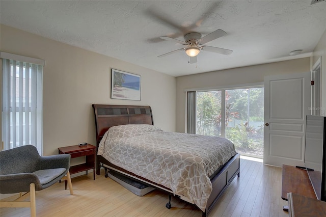 bedroom featuring light wood-type flooring, access to exterior, and ceiling fan