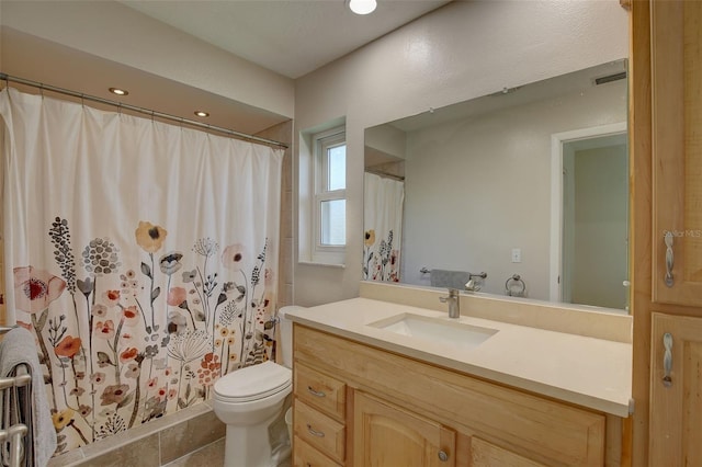 bathroom featuring vanity, a shower with shower curtain, and toilet