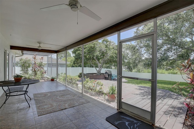 unfurnished sunroom featuring ceiling fan