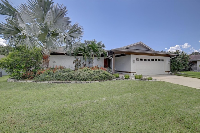 view of front of home with a garage and a front lawn