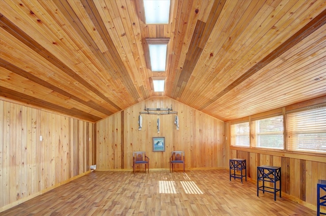 additional living space with light hardwood / wood-style flooring, wooden ceiling, and lofted ceiling with beams