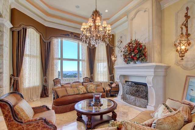 tiled living room with a notable chandelier, ornamental molding, a high end fireplace, and a raised ceiling